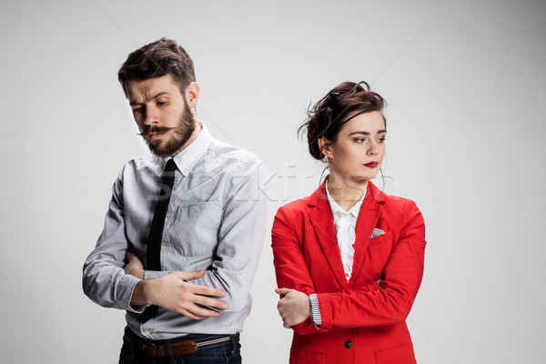 The sad business man and woman conflicting on a gray background Stock photo © master1305