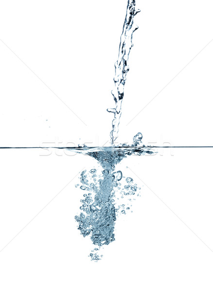 Water making bubbles upon being poured into more water. Stock photo © master1305