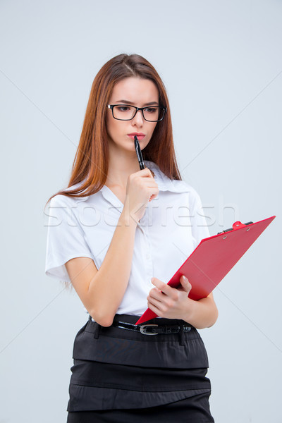 The young business woman with pen and tablet for notes on gray background Stock photo © master1305