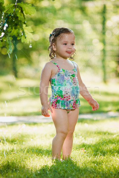 Kicsi kislány játszik kert locsoló nyár Stock fotó © master1305