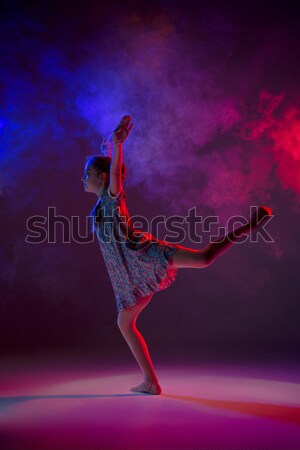 Stock photo: Young beautiful dancer in beige dress dancing on gray background