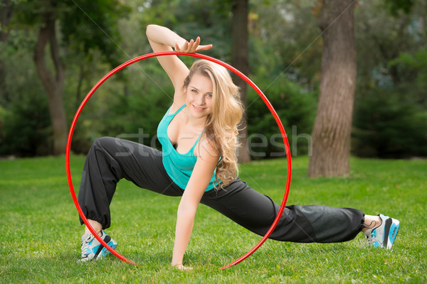 Young female athlete with hula hoop in the park Stock photo © master1305