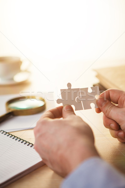 Stock photo: Building a business success. The hands with puzzles