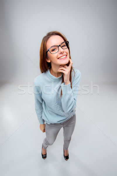 The smiling young business woman on gray background Stock photo © master1305