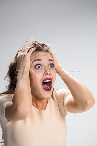 Portrait of young woman with shocked facial expression Stock photo © master1305