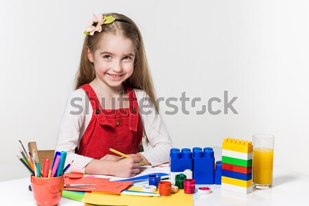 Cute little girl drawing with paint and paintbrush at home Stock photo © master1305