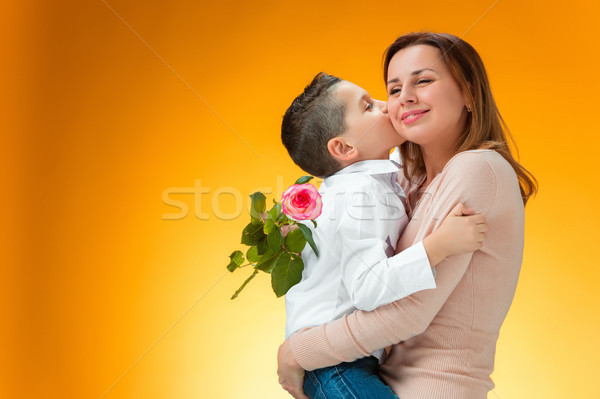 Young kid giving red rose to his mom Stock photo © master1305