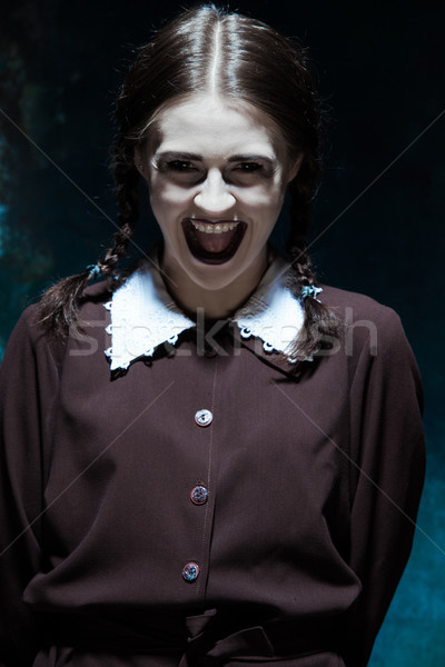 Portrait of a young smiling girl in school uniform as killer woman Stock photo © master1305