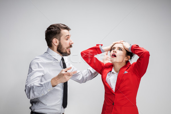 The business man and woman conflicting on a gray background Stock photo © master1305