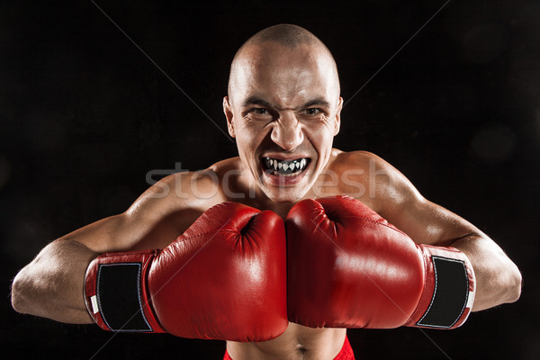 The young man kickboxing on black  with kapa in mouth Stock photo © master1305
