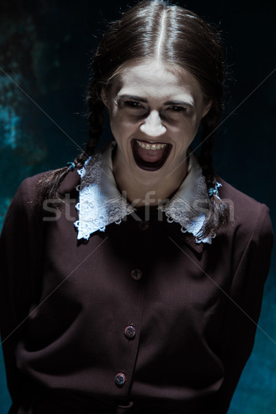 Portrait of a young smiling girl in school uniform as killer woman Stock photo © master1305