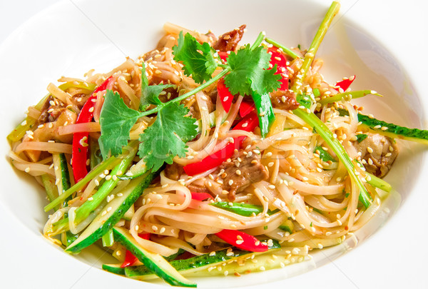 Stock photo: Pan-Asian rice noodles with beef, vegetables, bean sprouts in a sweet and sour sauce