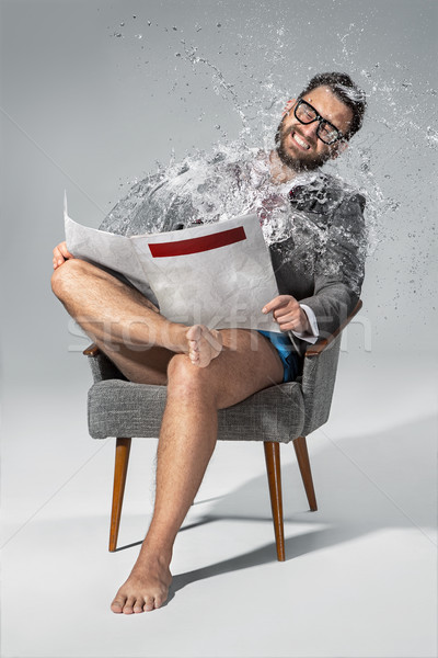 Man reading newspaper on gray background Stock photo © master1305