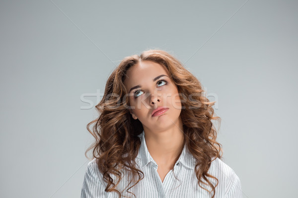 The happy thoughtful woman on gray background Stock photo © master1305