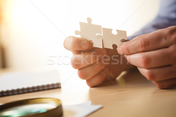 Building a business success. The hands with puzzles Stock photo © master1305