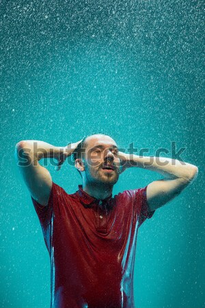 The portrait of young man in the rain Stock photo © master1305