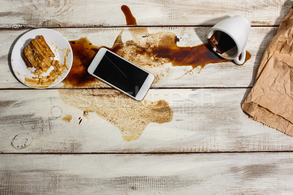 Cup of coffee spilled on wooden table Stock photo © master1305