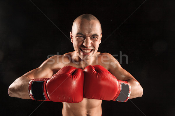 The young man kickboxing on black  with screaming face Stock photo © master1305