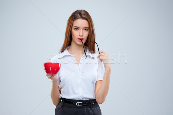 Stock photo: The young business woman on gray background