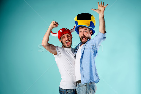 Stock photo: The two football fans over blue