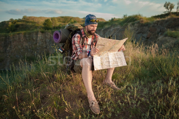 Young caucasian man with backpack sitting on the top of hill Stock photo © master1305