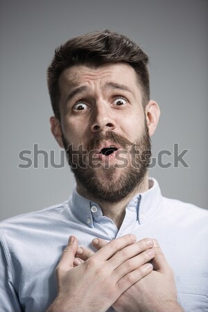 Man is looking imploring over gray background Stock photo © master1305