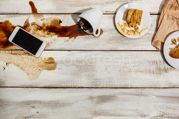 Cup of coffee spilled on wooden table Stock photo © master1305