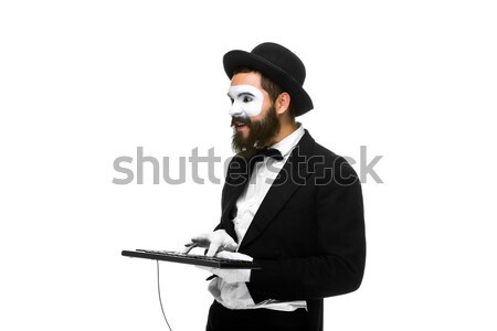 Stock photo: mime as a businessman holdinga keyboard