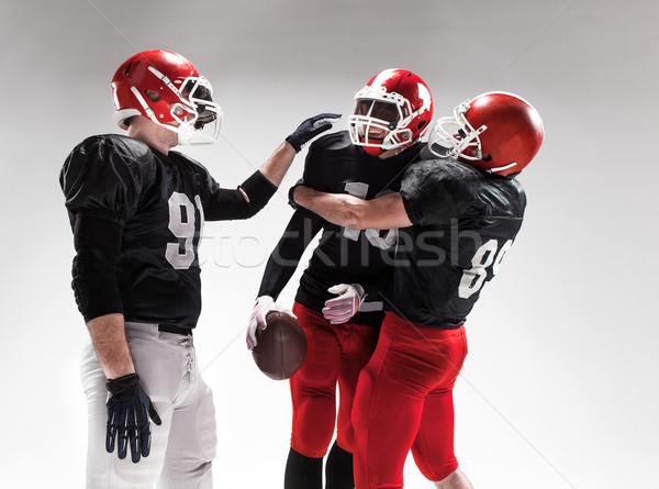 Stock photo: The three american football players posing on white background