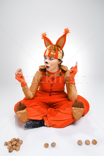 Young woman in the image of red squirrel with walnuts  Stock photo © master1305