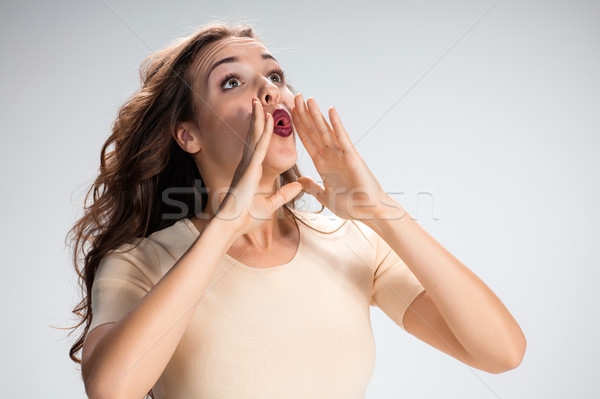 Stock photo: The calling girl or woman on gray background