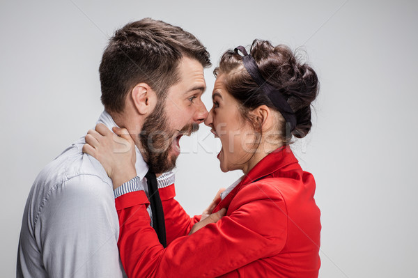The business man and woman conflicting on a gray background Stock photo © master1305