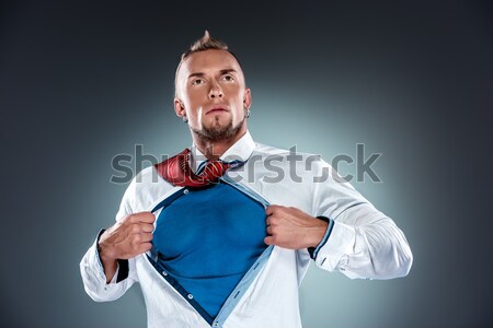 Stock photo: businessman acting like a super hero and tearing his shirt off
