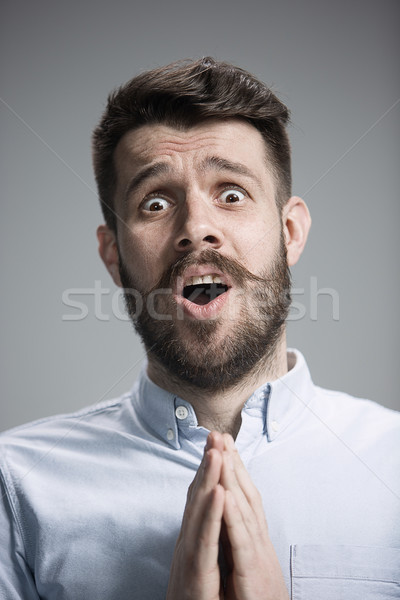 Man is looking imploring over gray background Stock photo © master1305