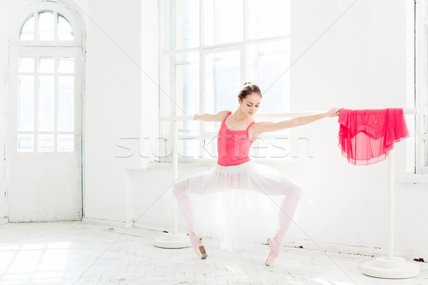 Stock photo: Ballerina posing in pointe shoes at white wooden pavilion