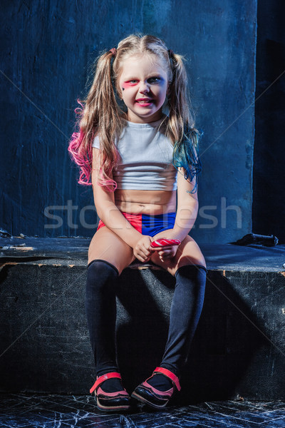 Stock photo: The funny crasy girl with candy on dark background