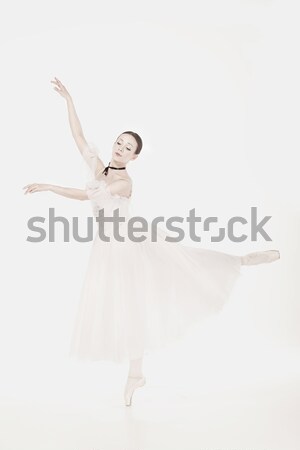 Ballerina in white dress posing on pointe shoes, studio background. Stock photo © master1305