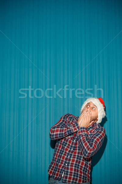Stock photo: frightened christmas man wearing a santa hat