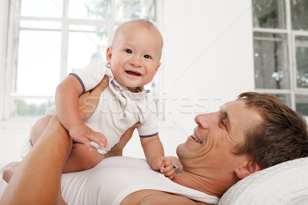 young father with his nine months old son on the bed at home Stock photo © master1305