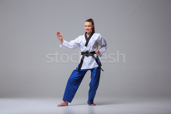 Stock photo: The karate girl with black belt 
