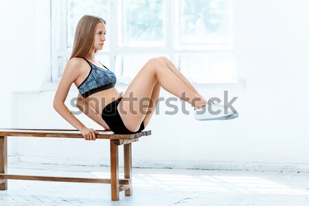 Beautiful slim brunette doing some push ups a the gym Stock photo © master1305