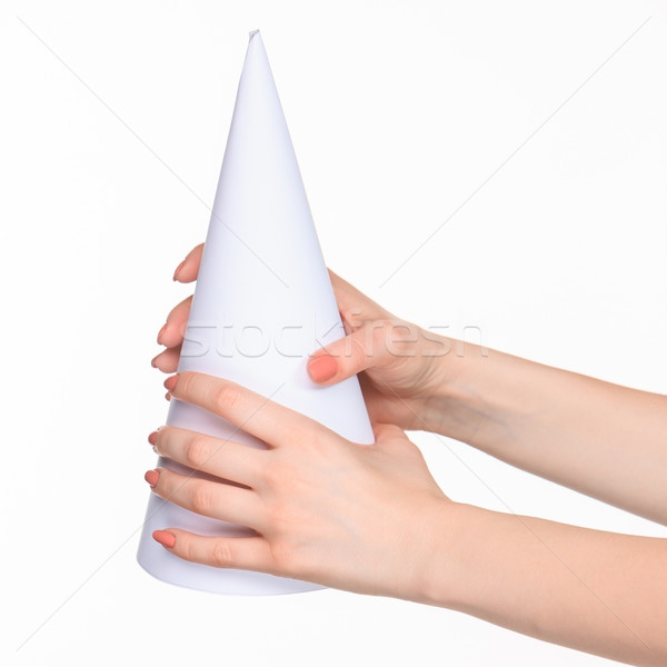 Stock photo: The white cone in the  female hands on white background