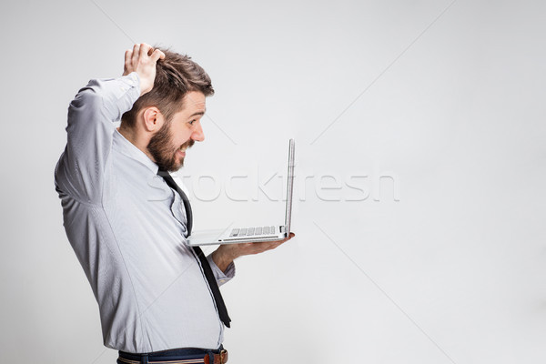Fiatal meglepődött férfi laptop számítógép szürke üzlet Stock fotó © master1305