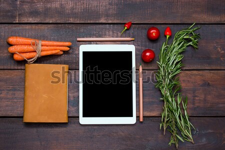 The tablet, notebook, fresh bitter and sweet pepper on wooden table background Stock photo © master1305