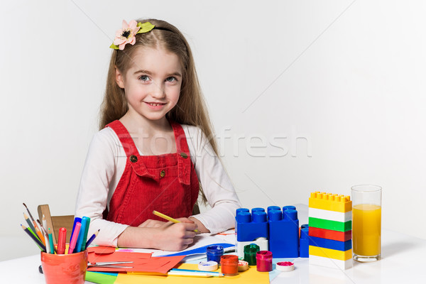 Cute little girl drawing with paint and paintbrush at home Stock photo © master1305