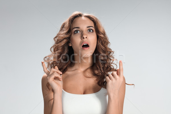 Portrait of young woman with shocked facial expression Stock photo © master1305