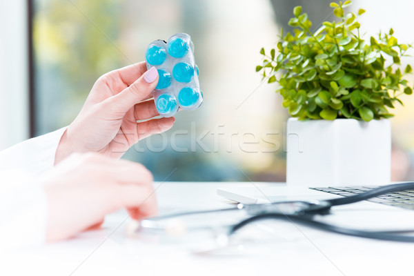 Hand of female medicine doctor holding tablet blister closeup.  Stock photo © master1305