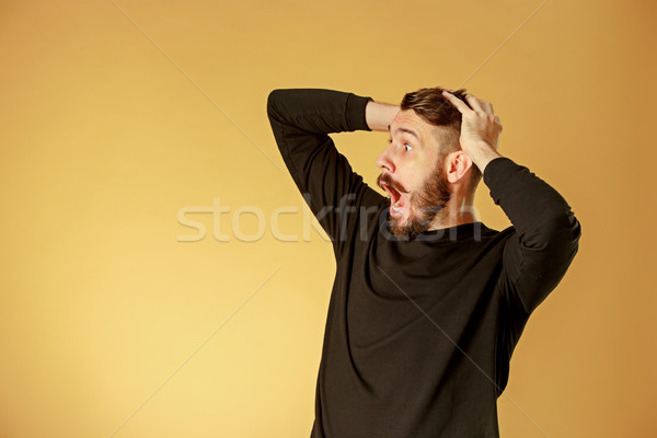Stock photo: Portrait of young man with shocked facial expression
