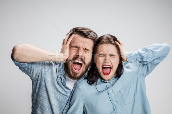 Close up photo of angry man and woman touching their heads Stock photo © master1305