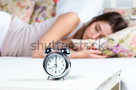 спальный кровать молодые красивая девушка часы Сток-фото © master1305